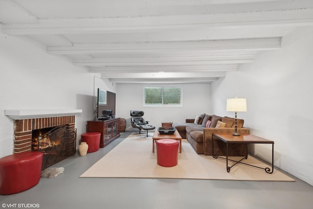 living room with a fireplace, concrete flooring, and beam ceiling