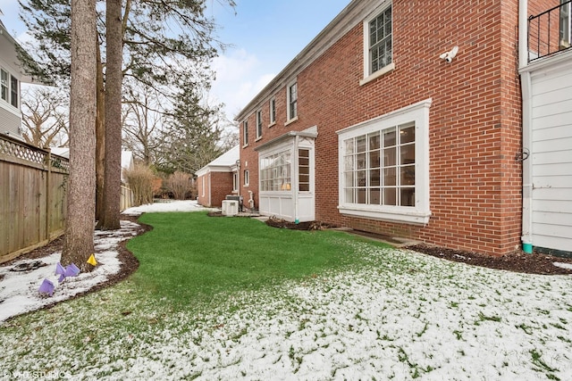 yard layered in snow with central AC unit