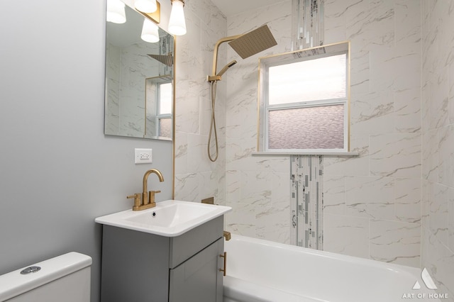 full bathroom with vanity, toilet, and tiled shower / bath combo