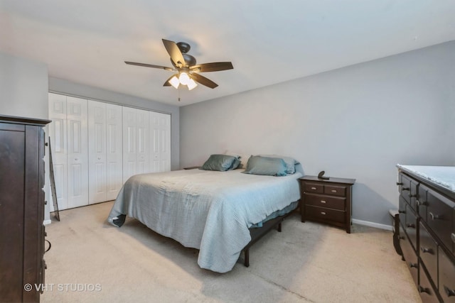 bedroom featuring ceiling fan, a closet, and light carpet