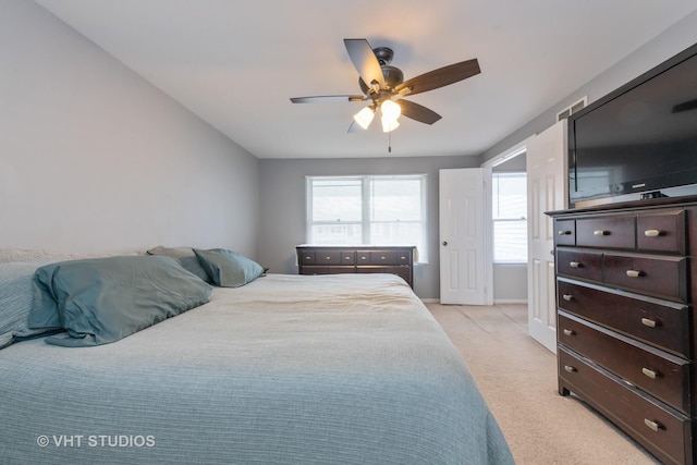 bedroom featuring light colored carpet and ceiling fan