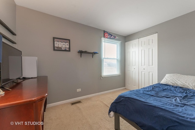 carpeted bedroom featuring a closet