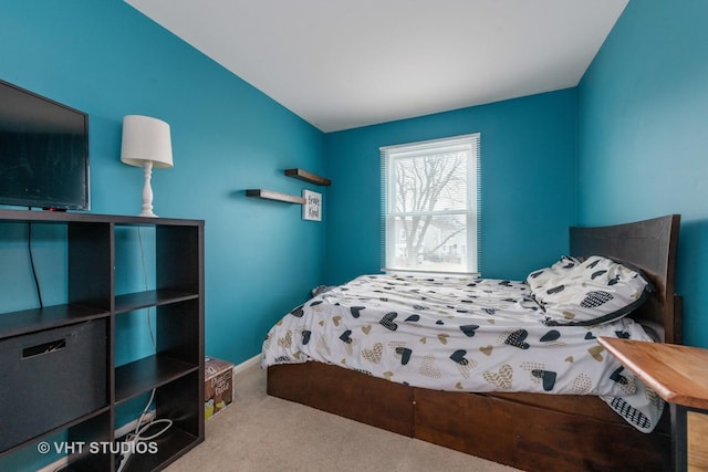 bedroom with carpet floors and vaulted ceiling