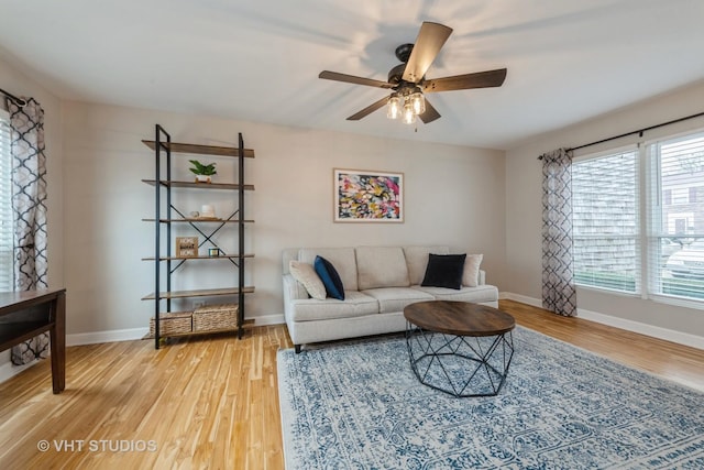 living room with hardwood / wood-style flooring and ceiling fan