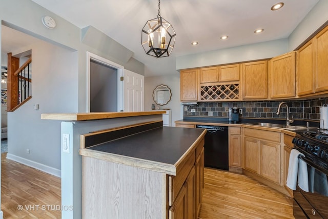 kitchen featuring backsplash, a kitchen island, hanging light fixtures, and black appliances