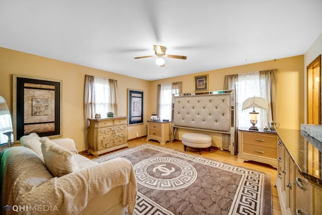 interior space with ceiling fan, light wood-type flooring, and multiple windows