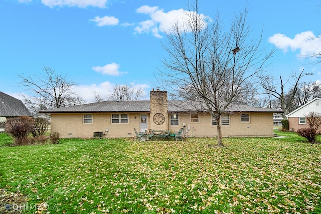 rear view of house with a lawn and central AC unit