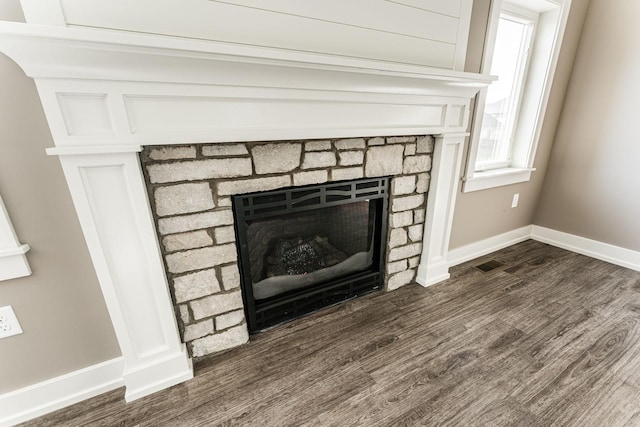 details with hardwood / wood-style floors and a fireplace