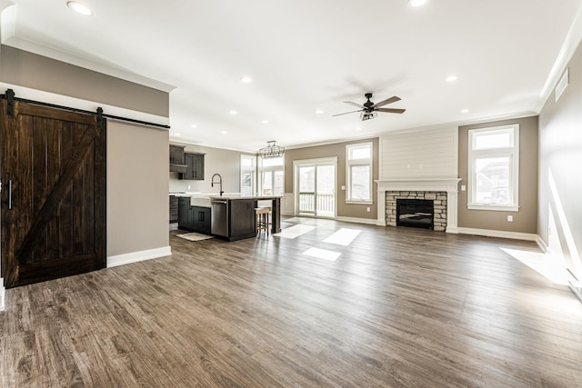 unfurnished living room featuring plenty of natural light and dark hardwood / wood-style floors