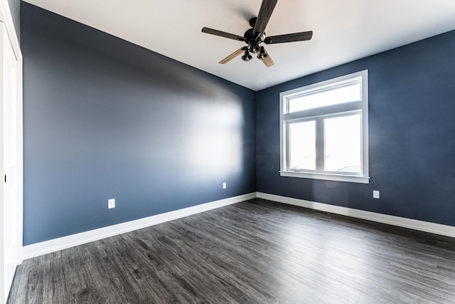 spare room featuring ceiling fan and dark hardwood / wood-style flooring