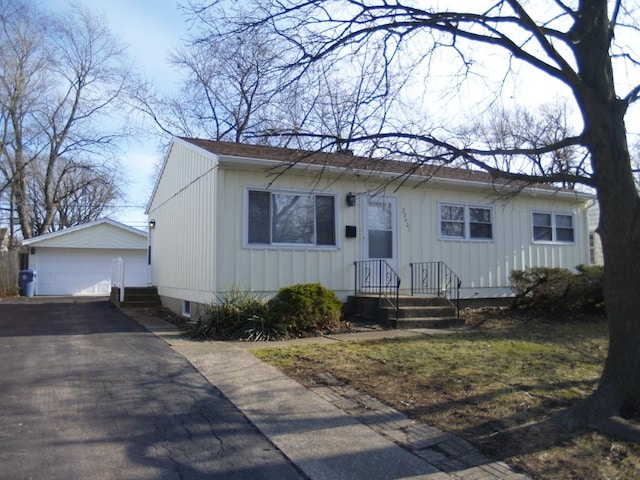 view of front of property with a garage and an outdoor structure