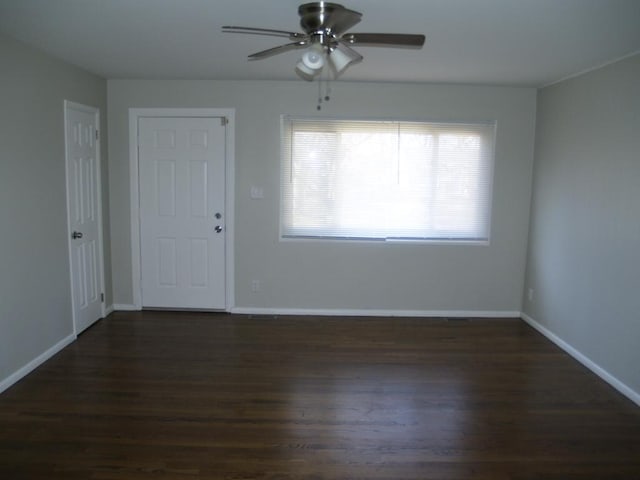 unfurnished room featuring ceiling fan and dark wood-type flooring