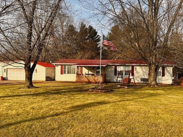 back of property with a lawn and a porch