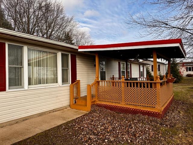 back of property featuring a wooden deck