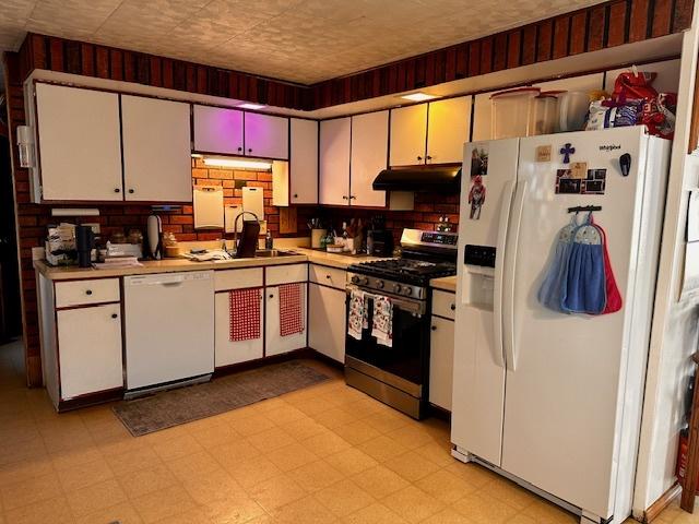 kitchen featuring sink and white appliances