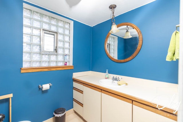 bathroom featuring vanity, tile patterned flooring, and toilet