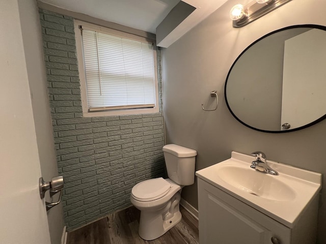 bathroom featuring vanity, wood-type flooring, and toilet