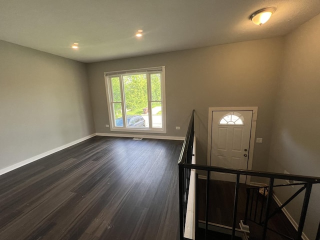 foyer with dark hardwood / wood-style floors