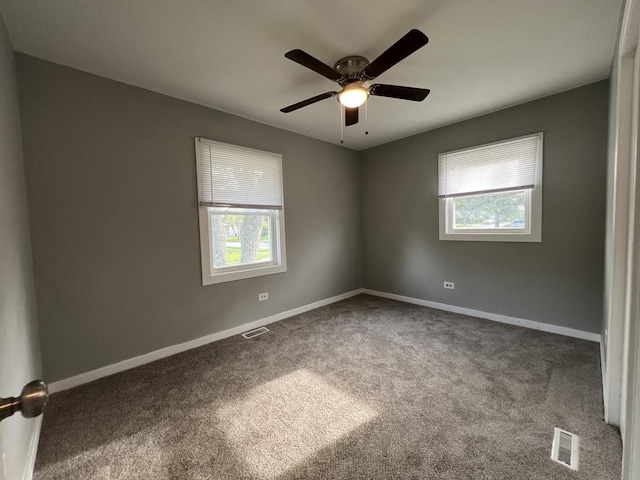 carpeted spare room featuring ceiling fan