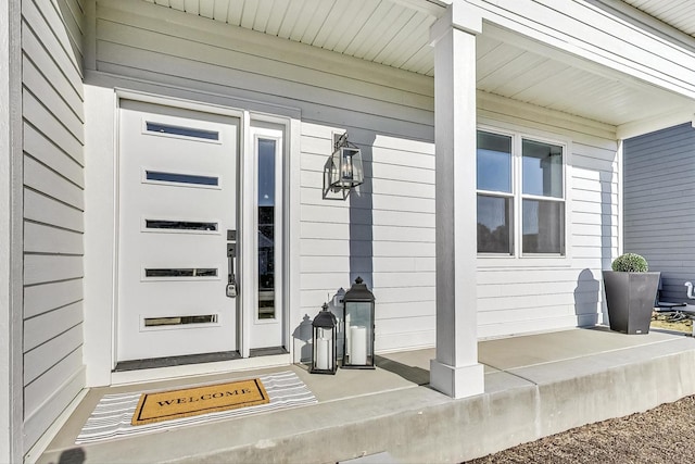 doorway to property featuring covered porch