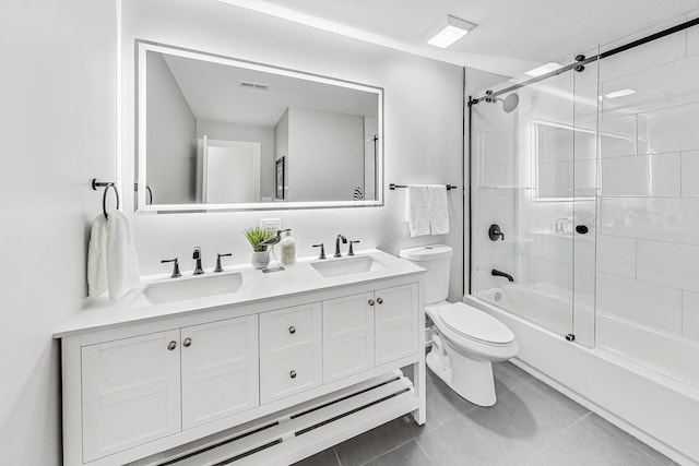 full bathroom with tile patterned flooring, shower / bath combination with glass door, vanity, and toilet