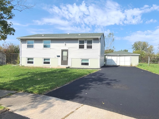 bi-level home featuring a garage, an outbuilding, and a front yard