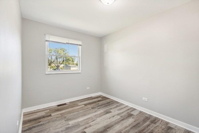 unfurnished room with hardwood / wood-style flooring