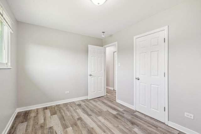 unfurnished bedroom featuring light wood-type flooring