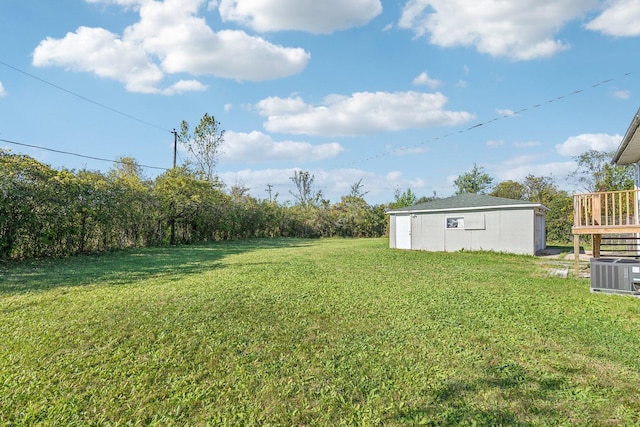 view of yard with an outdoor structure and central air condition unit