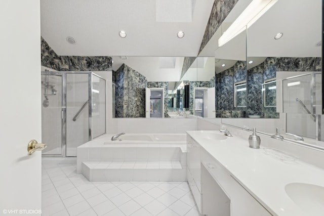 bathroom with tile patterned floors, vanity, and shower with separate bathtub