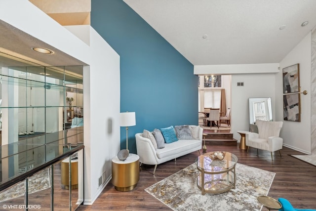 living room featuring dark hardwood / wood-style flooring and a towering ceiling