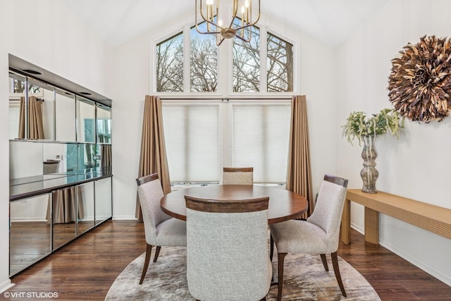 dining space with dark hardwood / wood-style flooring, high vaulted ceiling, and an inviting chandelier