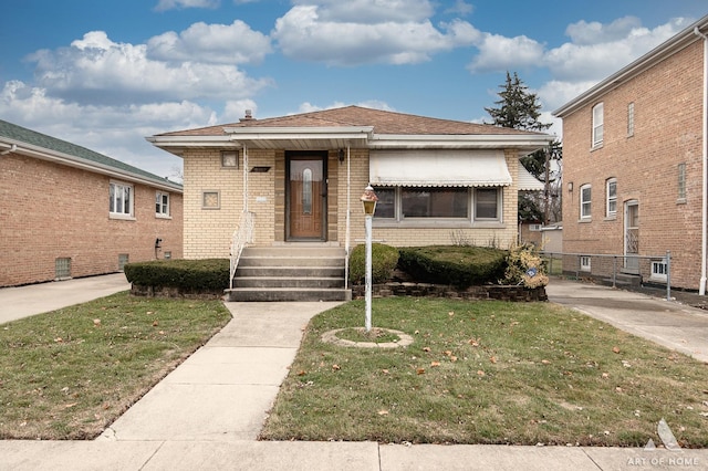 bungalow-style home featuring a front lawn