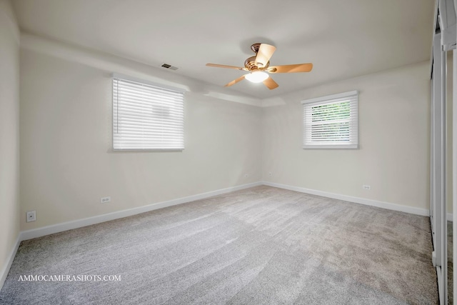 1607 Warwick Ln, Schaumburg, IL 60193 - empty room with a ceiling fan and carpet flooring