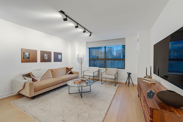 living room featuring track lighting and hardwood / wood-style flooring