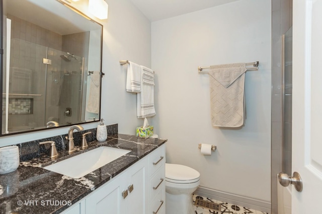 bathroom featuring vanity, toilet, and walk in shower