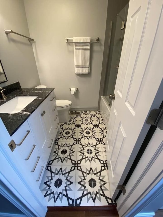 full bathroom featuring vanity, tile patterned flooring, plus walk in shower, and toilet