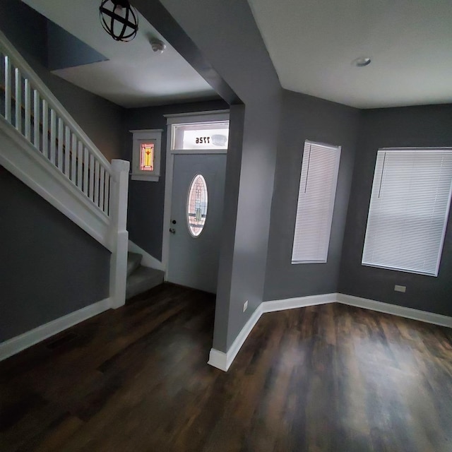 entryway with dark hardwood / wood-style flooring