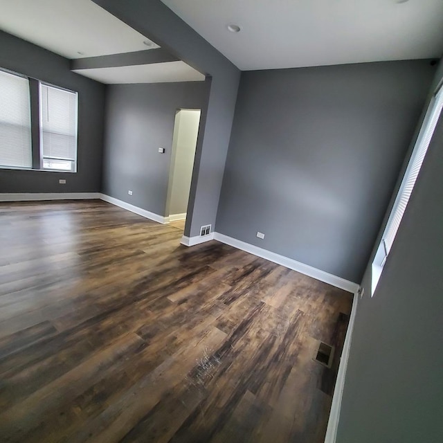 unfurnished room featuring dark wood-type flooring