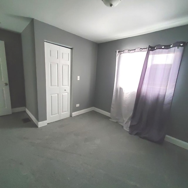 unfurnished bedroom featuring a closet and carpet floors