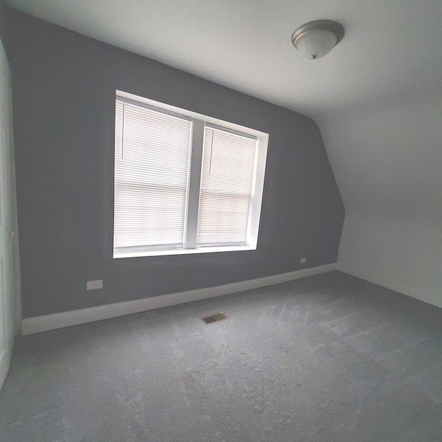 bonus room with carpet and vaulted ceiling