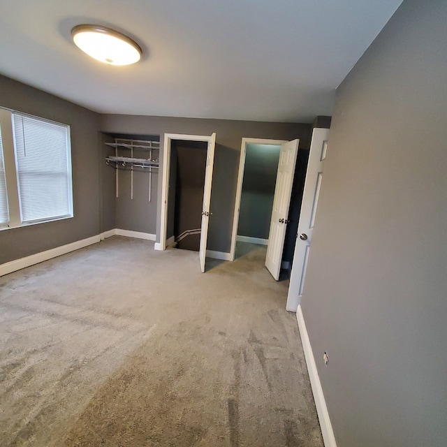 unfurnished bedroom featuring light colored carpet