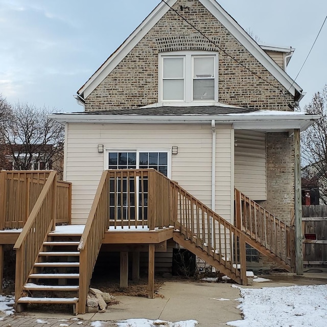 snow covered property featuring a wooden deck