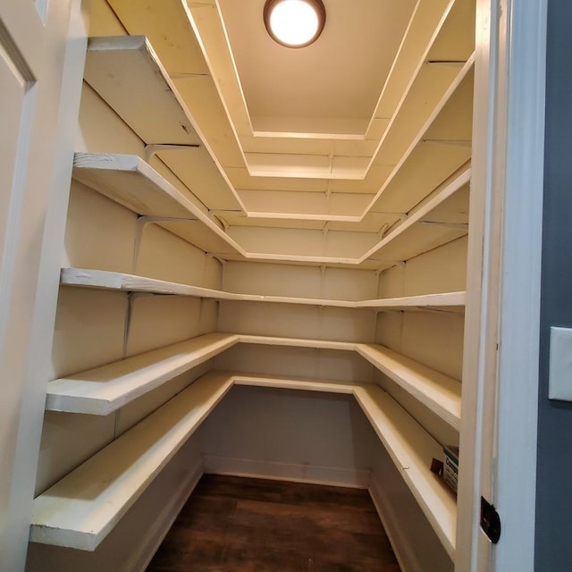 unfurnished bedroom with ceiling fan, dark hardwood / wood-style flooring, and stainless steel refrigerator