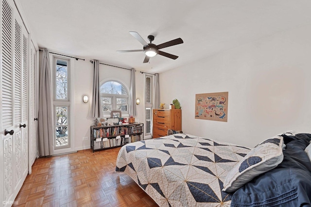 bedroom with parquet floors and ceiling fan