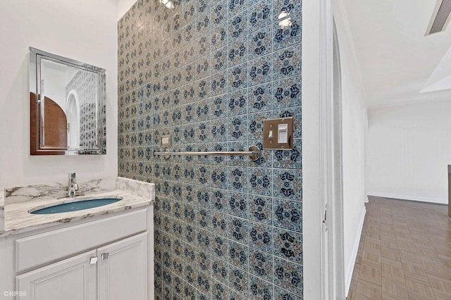 bathroom with vanity and parquet floors