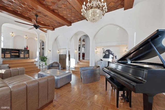 sitting room featuring ceiling fan with notable chandelier, brick ceiling, and lofted ceiling with beams