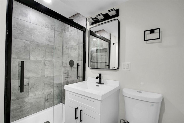 bathroom with vanity, an enclosed shower, and toilet