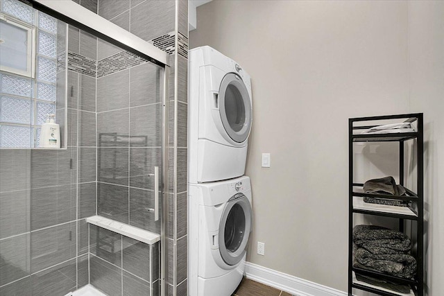 clothes washing area with stacked washer and clothes dryer