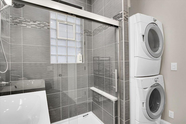 bathroom featuring stacked washer / dryer, an enclosed shower, and toilet